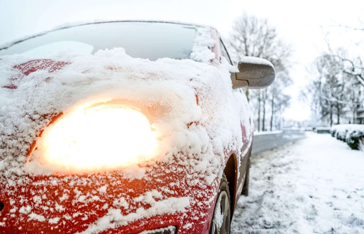 Snow covered red car