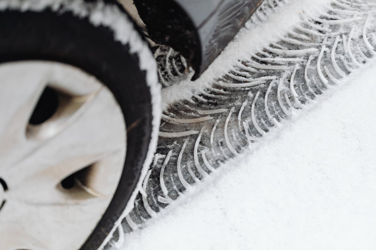 Vehicle Leaving Tire Tracks on Snow Covered Ground